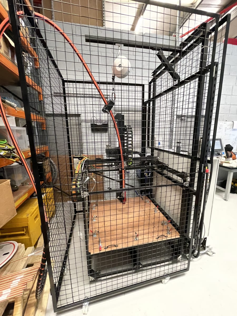 A concrete 3D printer laying down structure
